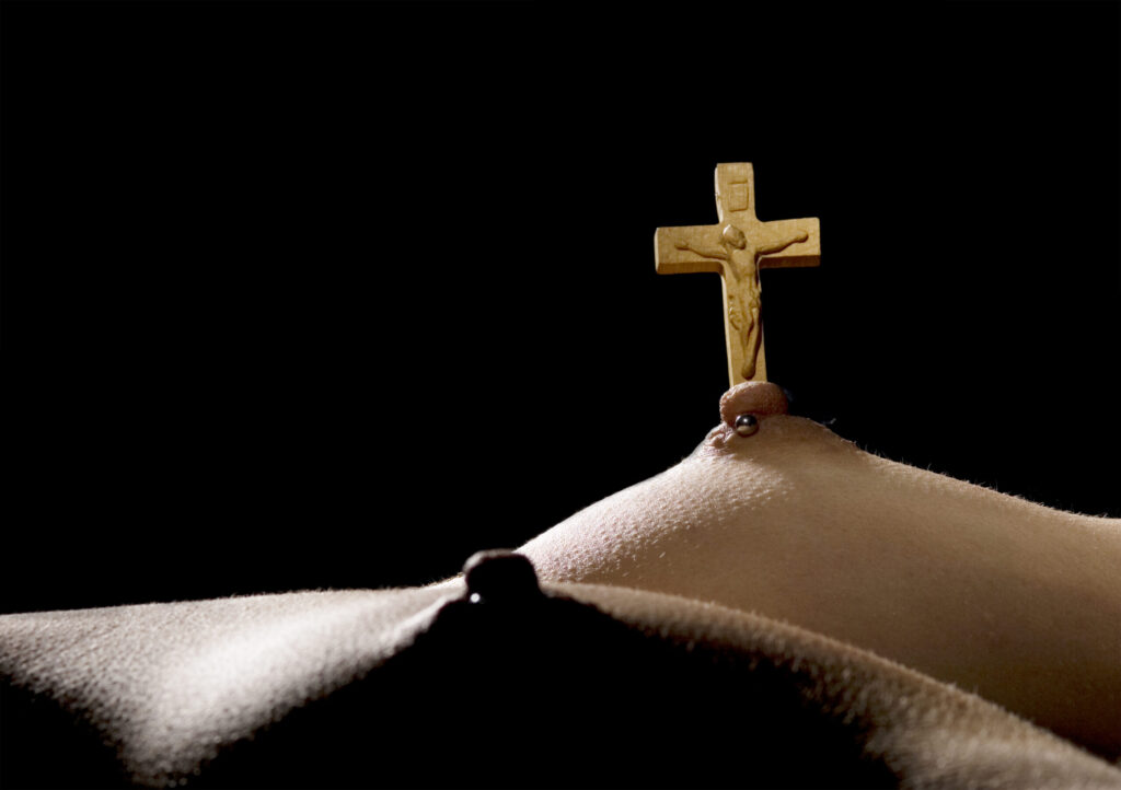 cross emerging from nipple